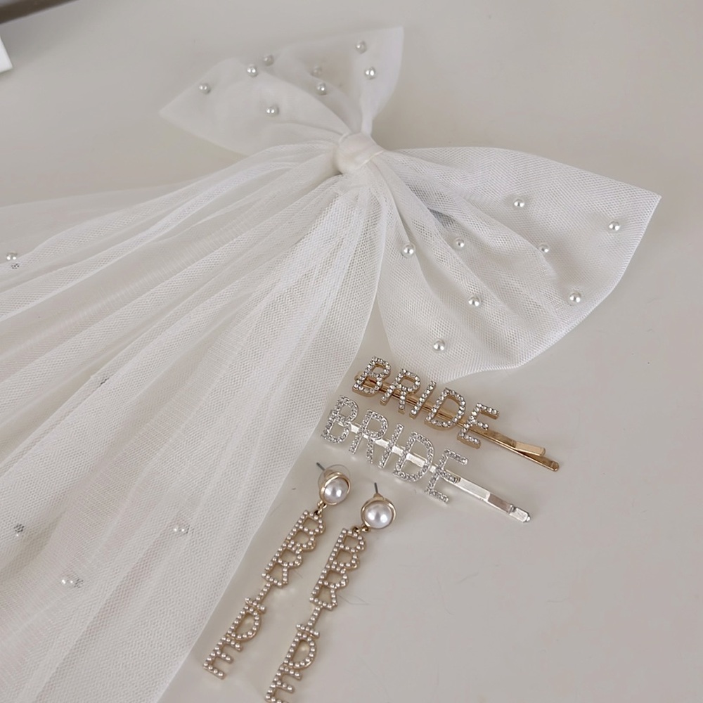 Six stories bridal hair bow with bride earrings and hair pins  from Francesca’s